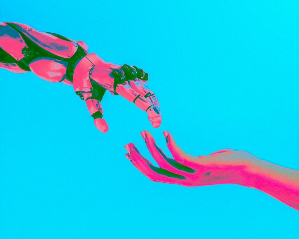Two stylized, pixelated hands reaching toward each other against a bright cyan background, rendered in pink and green tones.