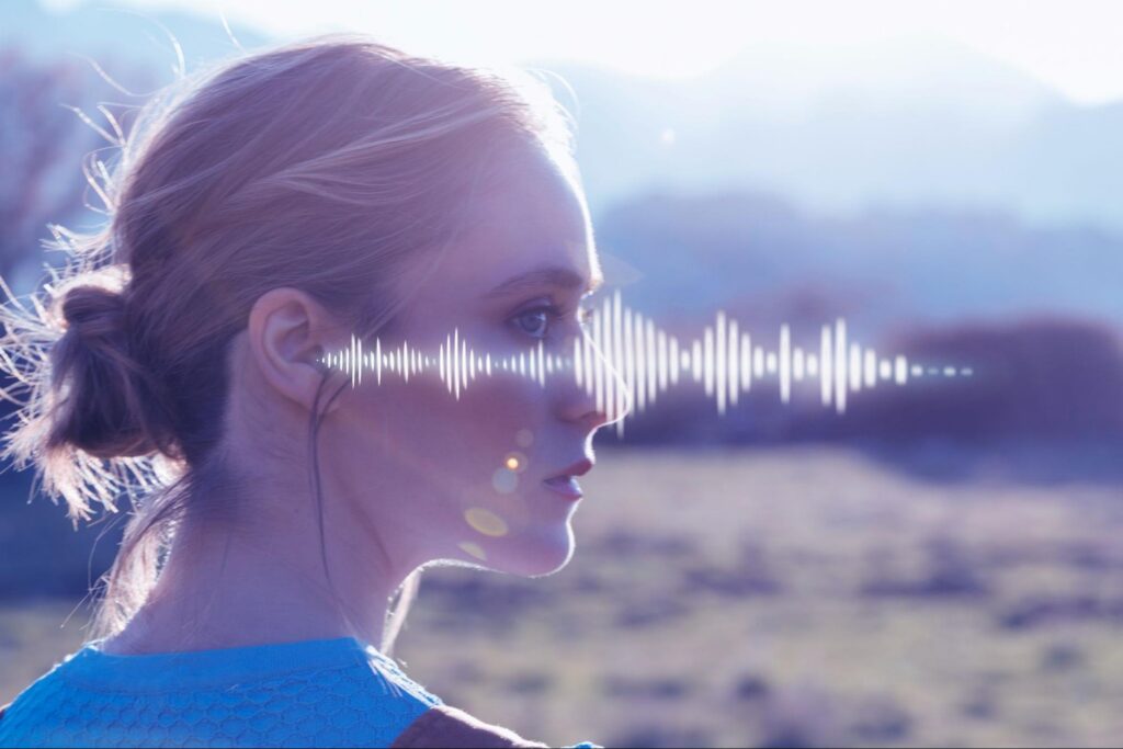 an image that displays a woman on a hike interacting with AI through audio waveform