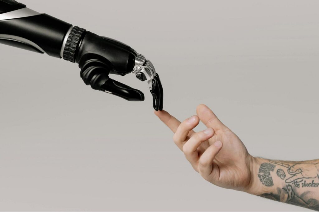 a computer generated image of an AI robotic hand making contact with a real world human hand. a computer generated image of an AI robotic hand making contact with a real world human hand.